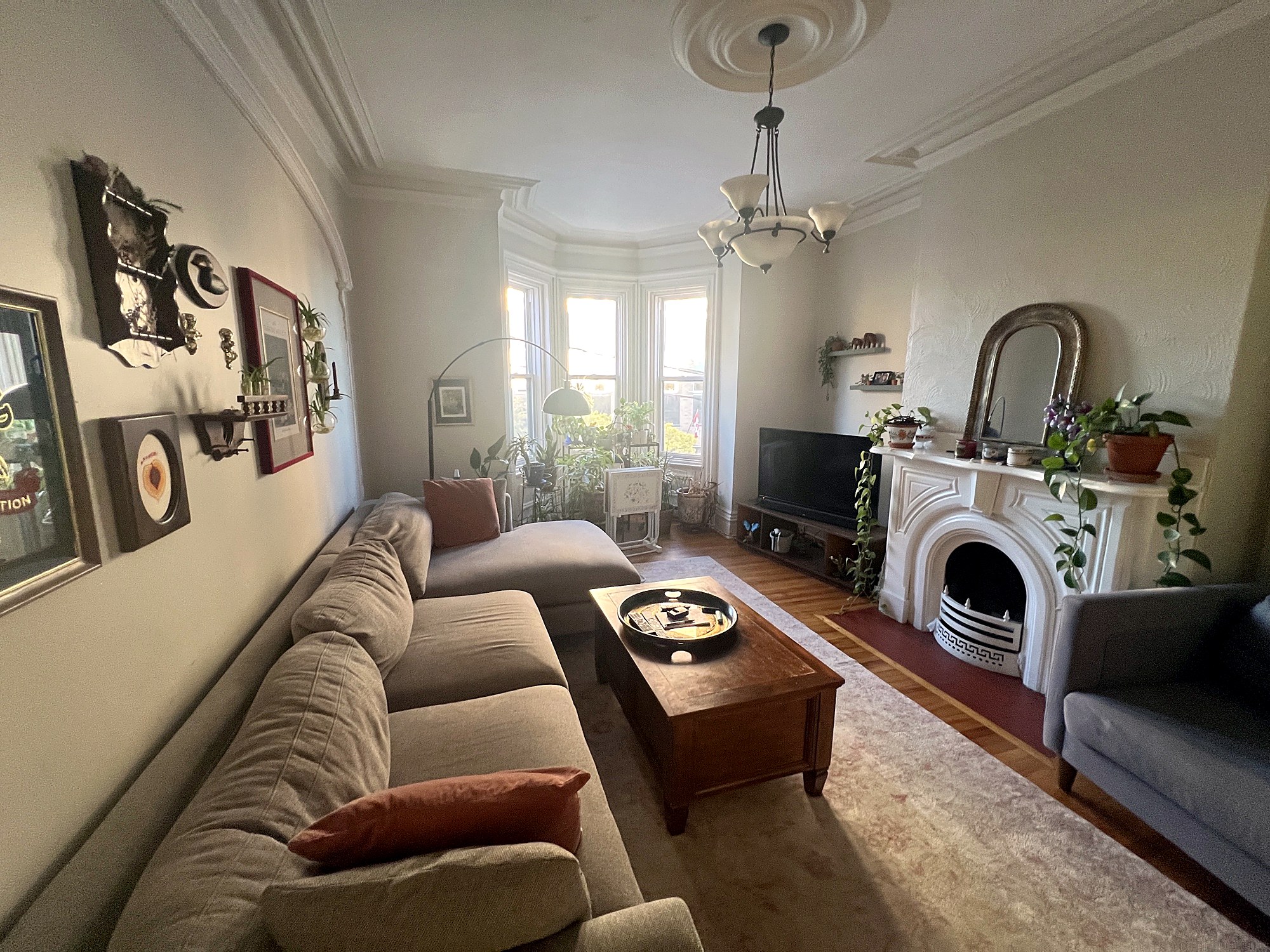 Bright living room with bay windows and fireplace